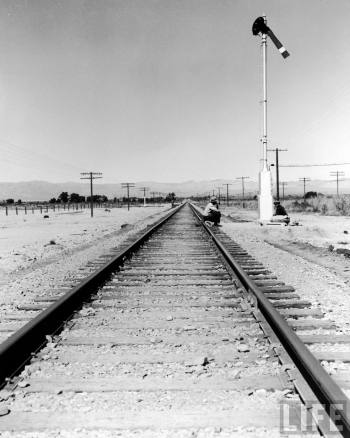 Itinerant men, aka. hoboes, waiting w. their bindles to illegally hop aboard a freight train calipatria CA 39